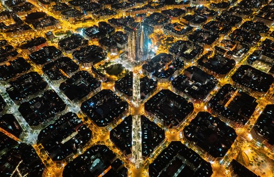 Aerial view of Sagrada Família glowing at night in Barcelona city lights