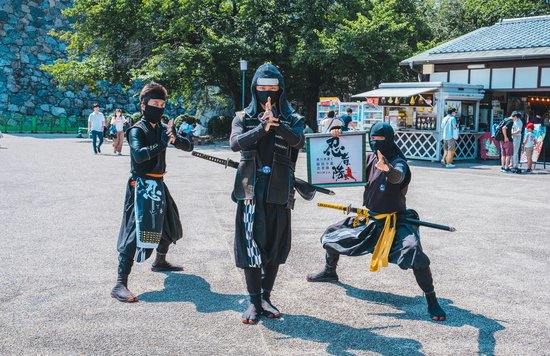 Ninja performers posing in traditional attire near a Nagoya castle | Photo Credit: Roméo A. on Unsplash