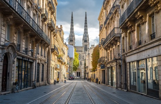 Historic street view of Bordeaux with Saint-André Cathedral in the distance