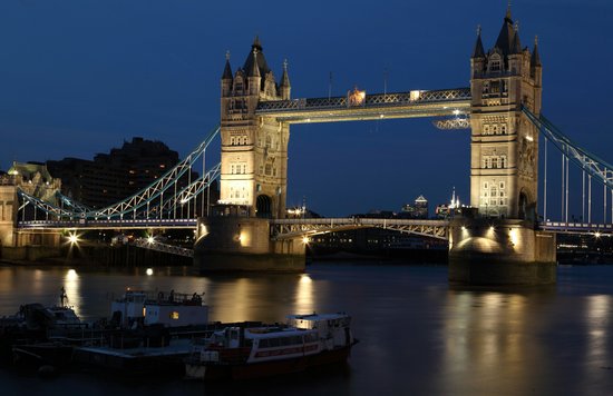 Tower Bridge glowing over the Thames during a calm London evening | Photo by Public Domain Pictures on Pexels