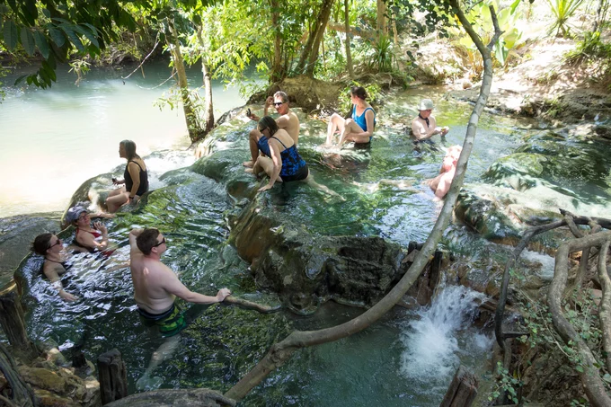 people bathing in Namtok Ron hot springs