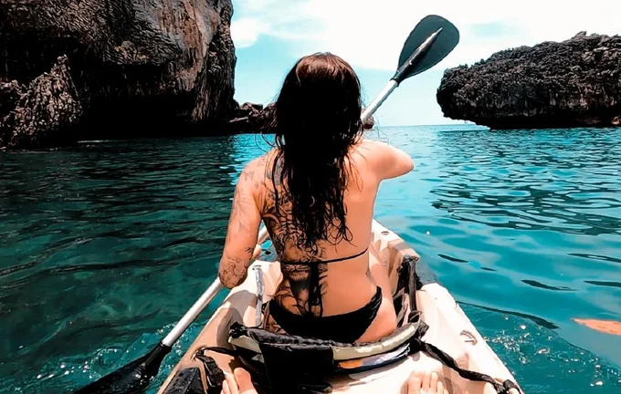 a woman kayaking around Krabi