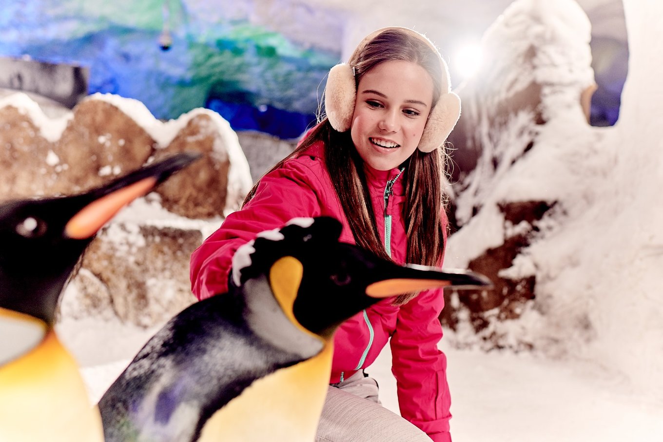 woman playing with a penguin at ski dubai