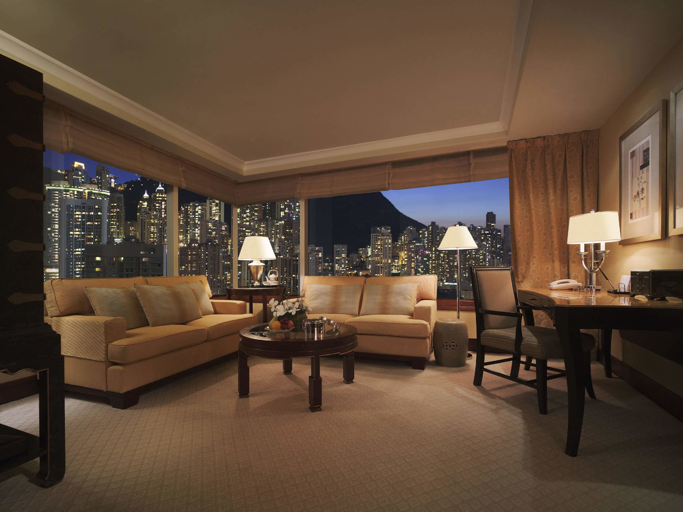 living area with city peak views at conrad hong kong