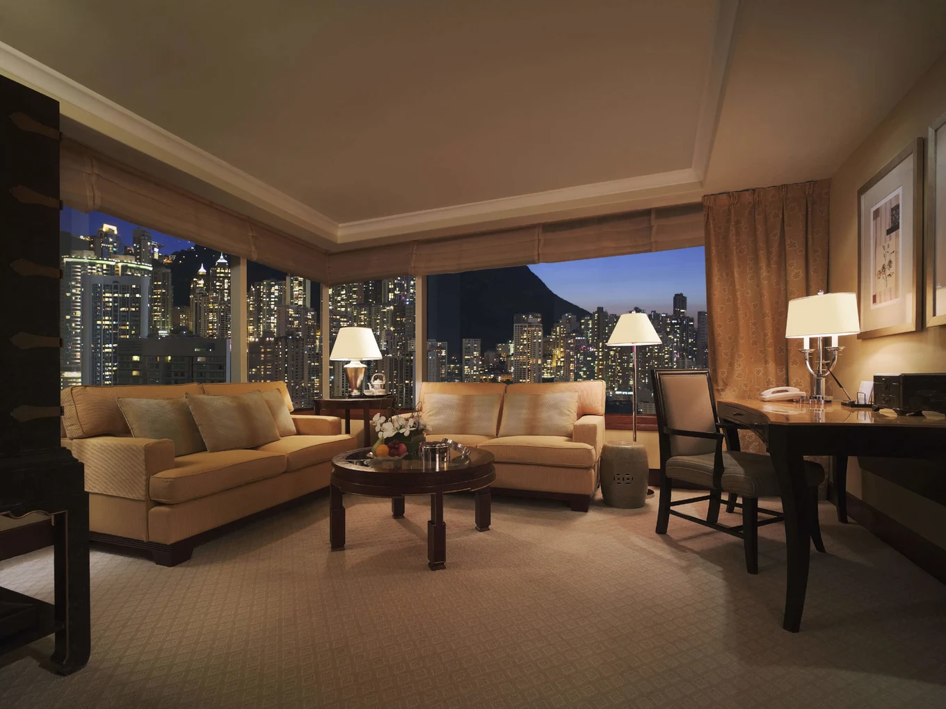 living area with city peak views at conrad hong kong
