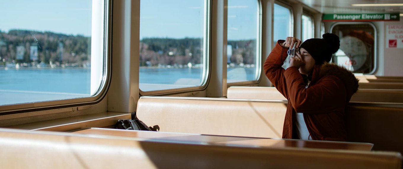 woman taking a photo from a car