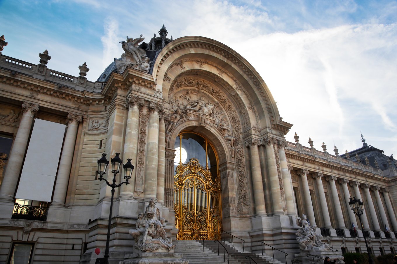 the entrance of paris' petit palais, with its iconic gilded gate and carvings