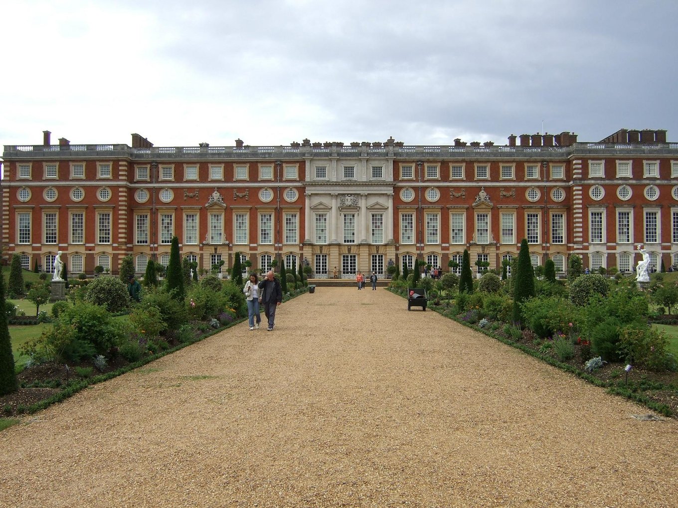 people in front of hampton court palace london uk