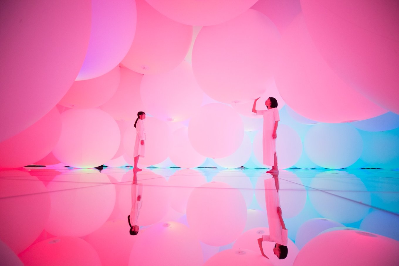 Two ladies standing in an art exhibition at teamLab Planets Tokyo