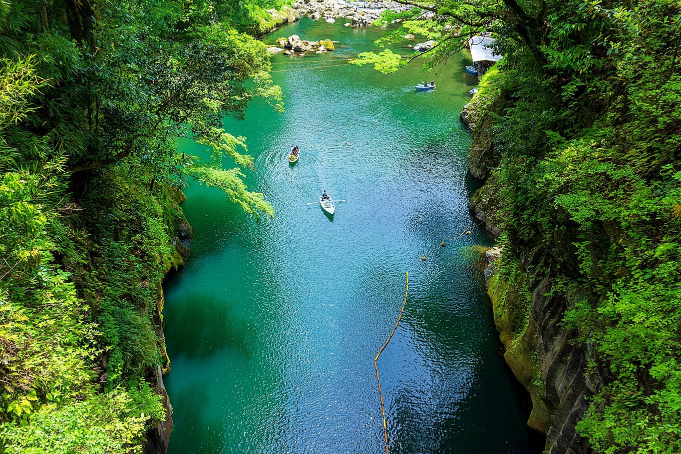 people kayaking through a gorge