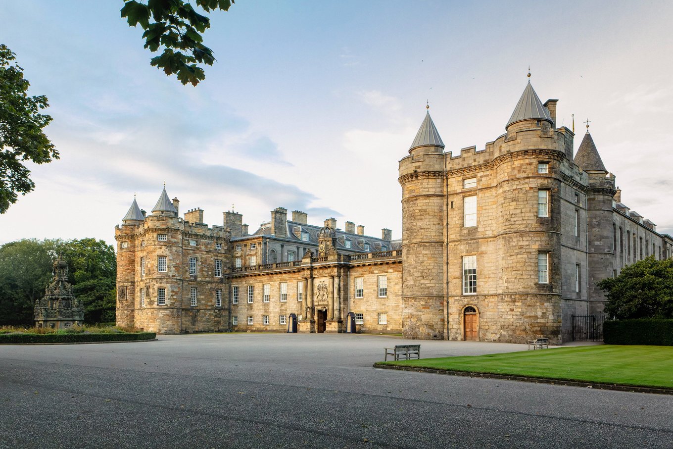 Front view of Holyrood Palace with towers and courtyard at sunset