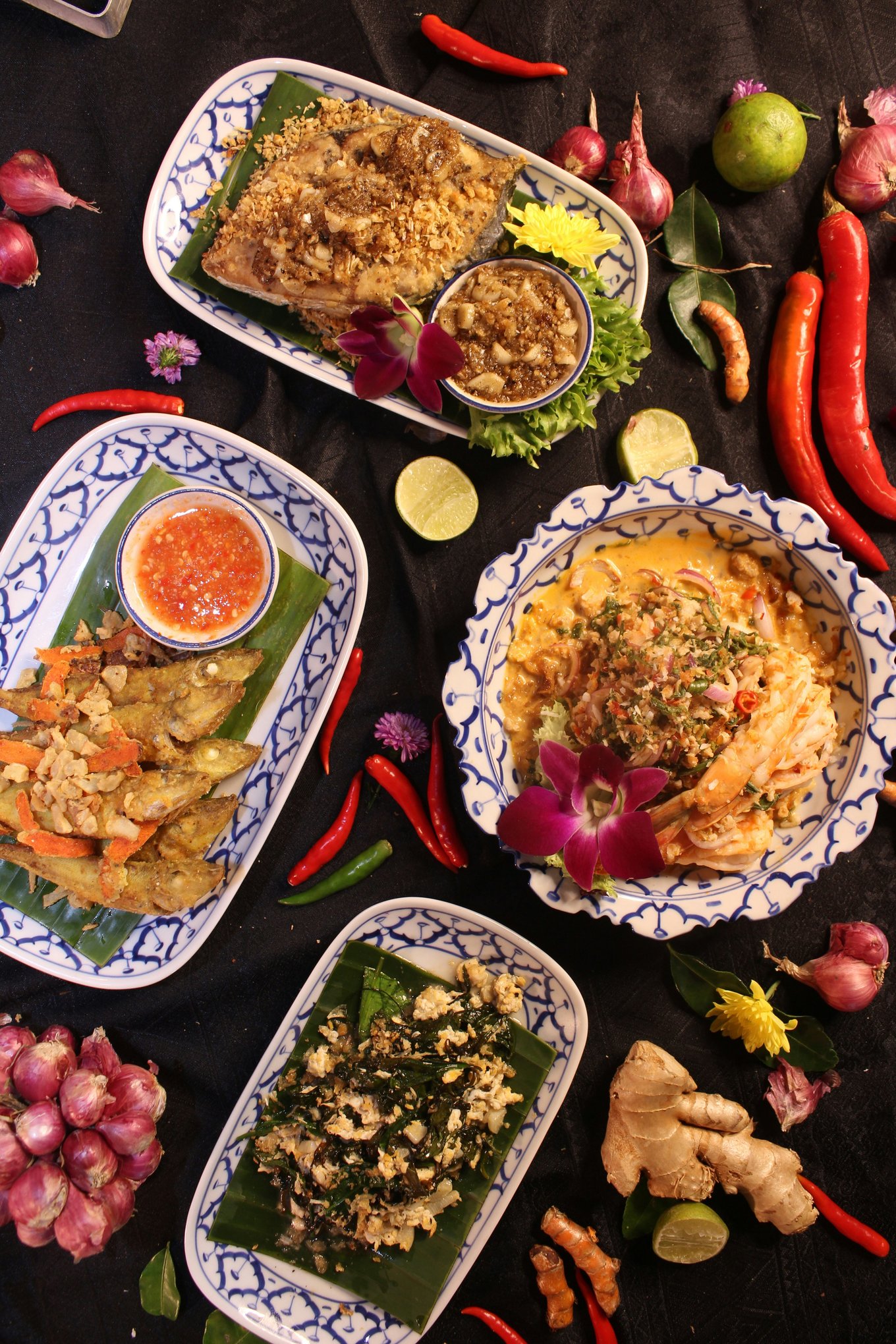 A colorful table setting of different kinds of Thai dishes