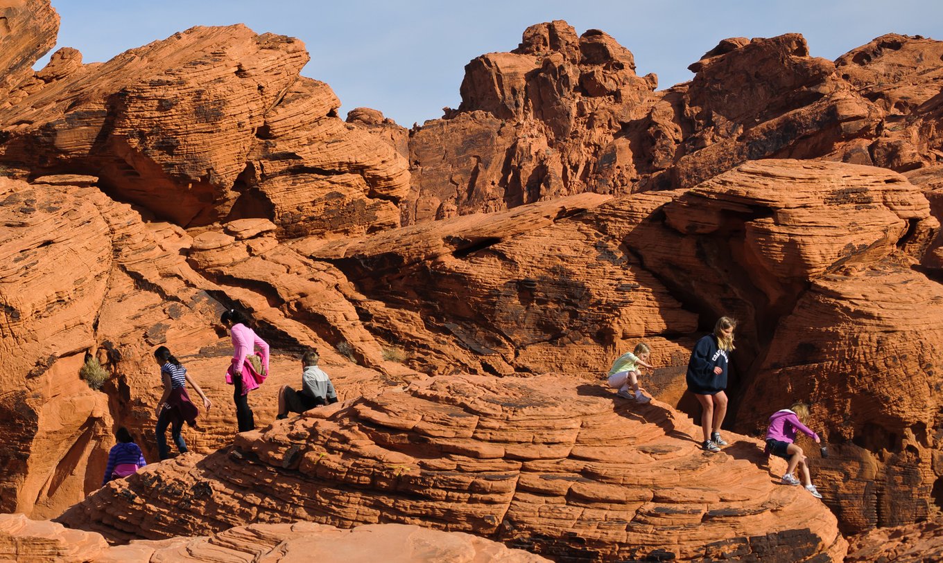 Visitors exploring red sandstone formations at Valley of Fire State Park