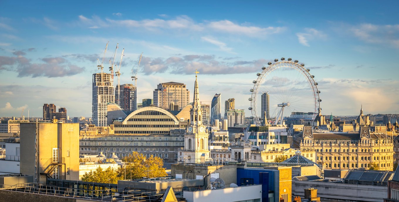 Panoramic view of London skyline featuring the London Eye and historic buildings