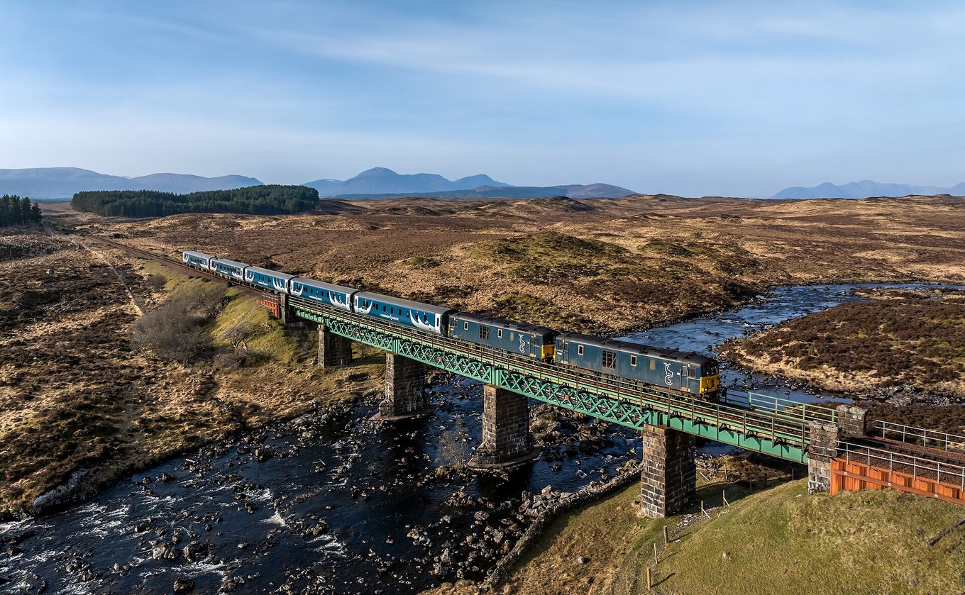 Caledonian Sleeper Train crossing a bridge through the Scottish Highlands | Photo from Kabelleger on Wikimedia Commons