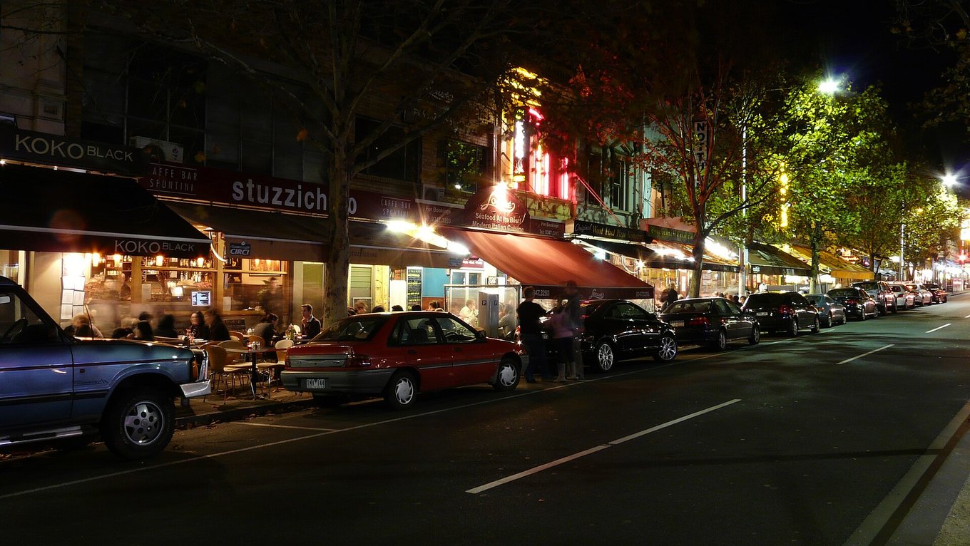 Busy Melbourne street at night with popular bars, restaurants, and nightlife energy
