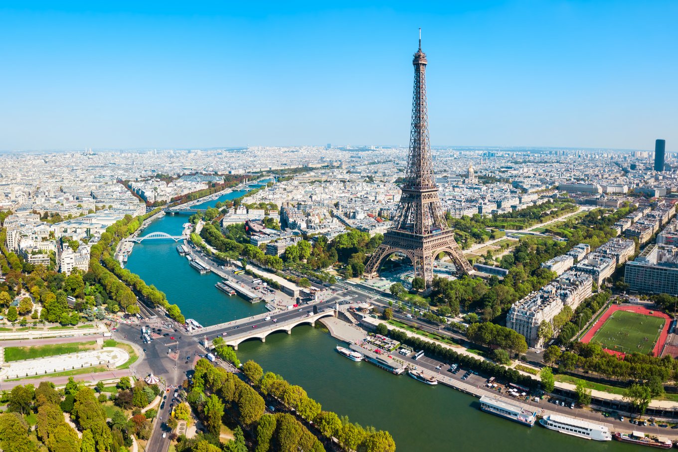 Panoramic aerial view of Paris featuring the Eiffel Tower and Seine River