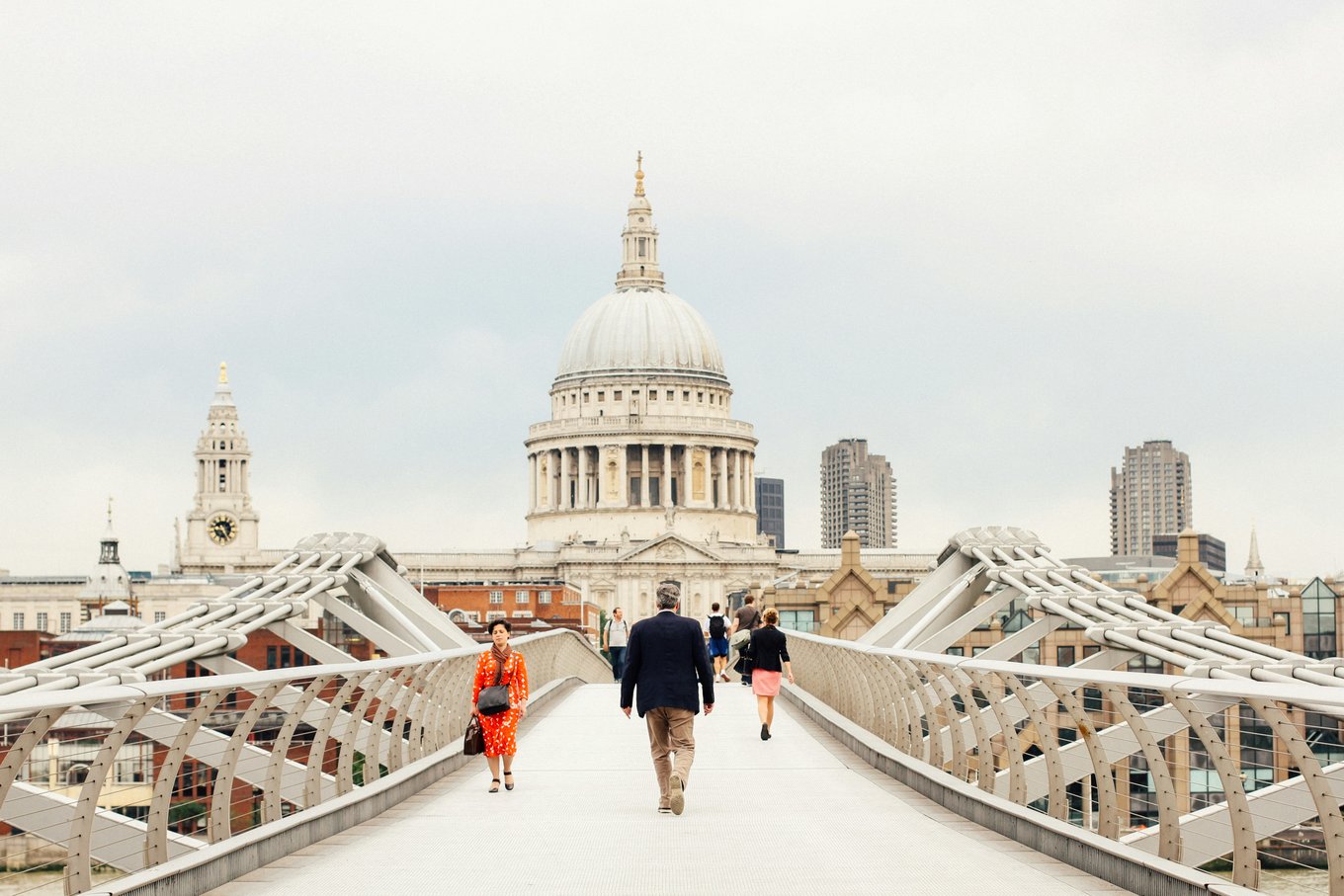People walking in Millennium Bridge in London | Photo Credit: Yulia Chinato on Unsplash