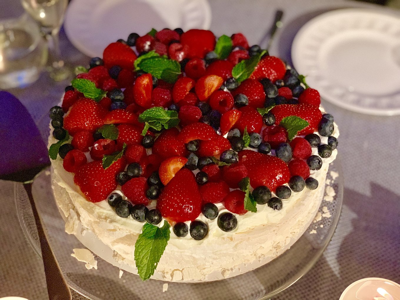 Pavlova dessert with strawberries, blueberries, and cream in New Zealand