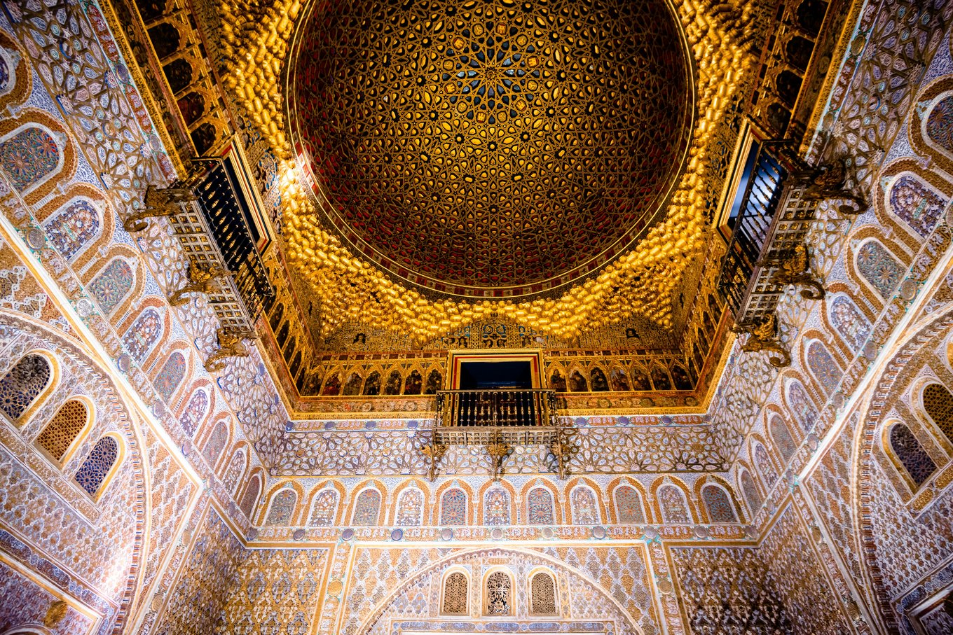 Ornate golden dome and patterned walls inside a historic palace in Seville | Photo Credit: Akshay Nanavati on Unsplash