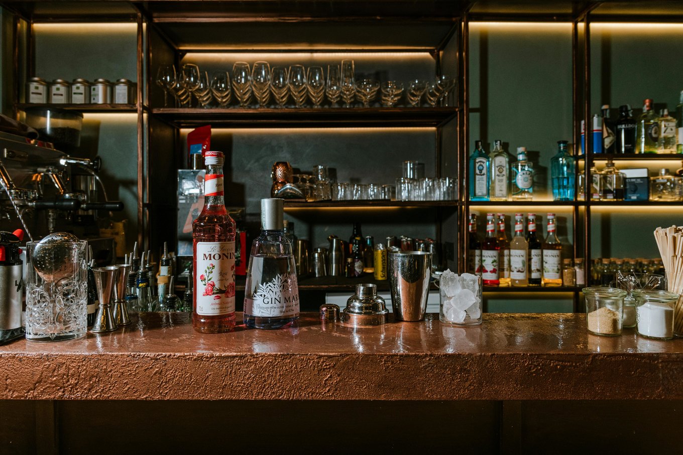 Stylish bar setup with gin bottles and glassware in Auckland bar