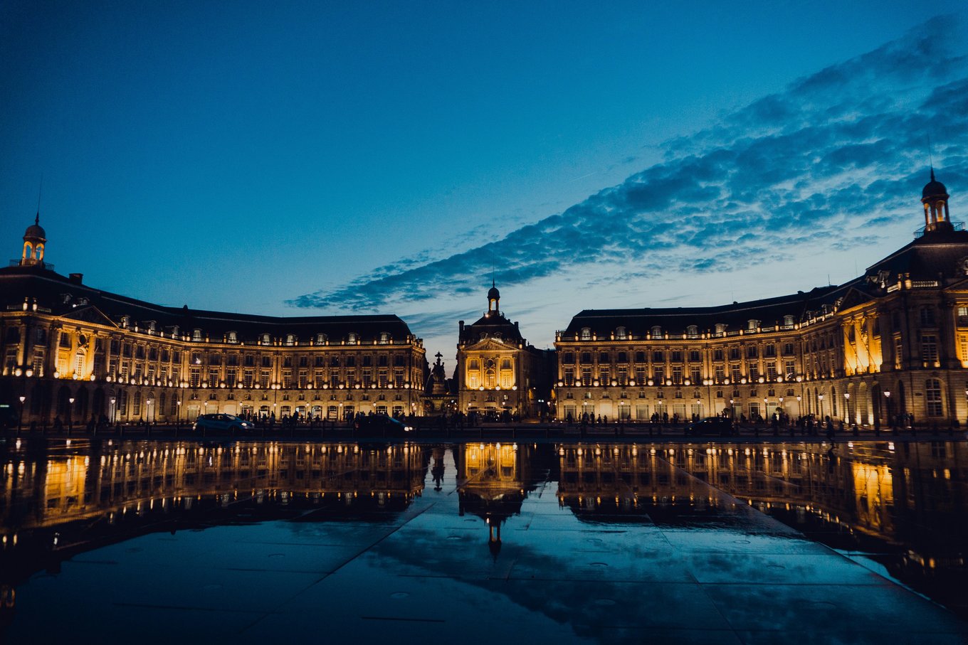 Bordeaux city center at night reflected in the Water Mirror | Photo Credit: Juan Di Nella on Unsplash
