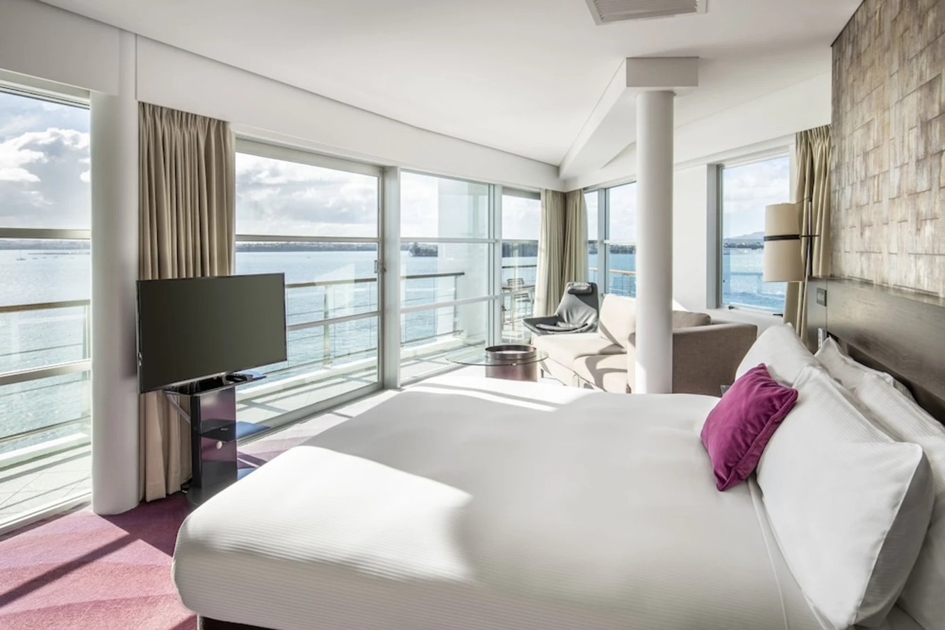 Hilton Auckland guest room overlooking the harbor with floor-to-ceiling windows