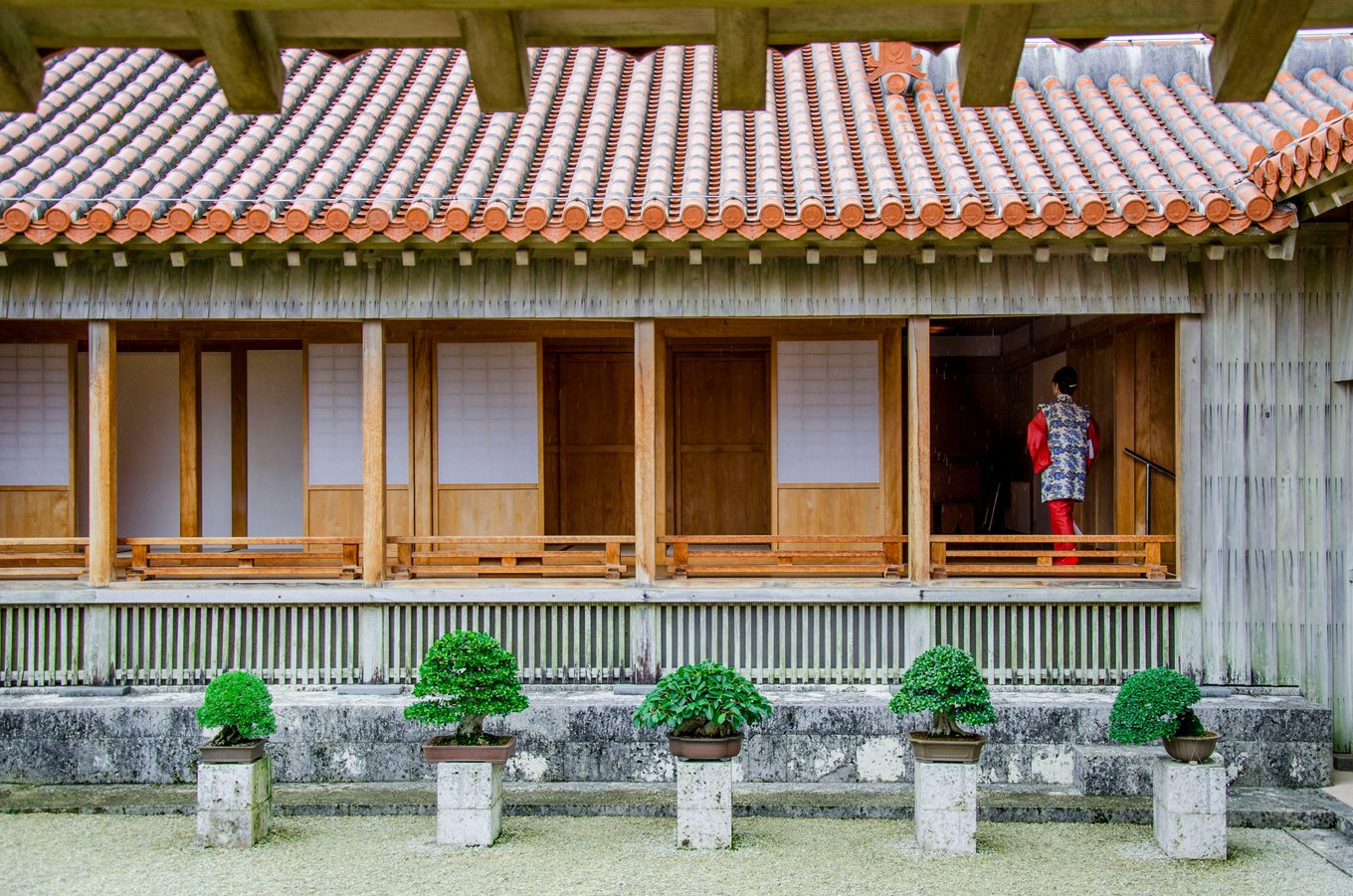 Traditional Okinawa house with tiled roof and wooden veranda | Photo Credit: Julie Fader on Unsplash 