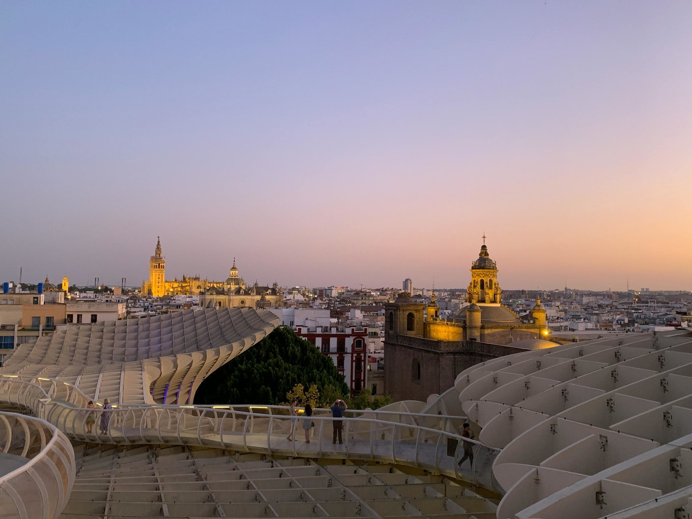 View of Seville skyline at sunset with Metropol Parasol and Seville Cathedral