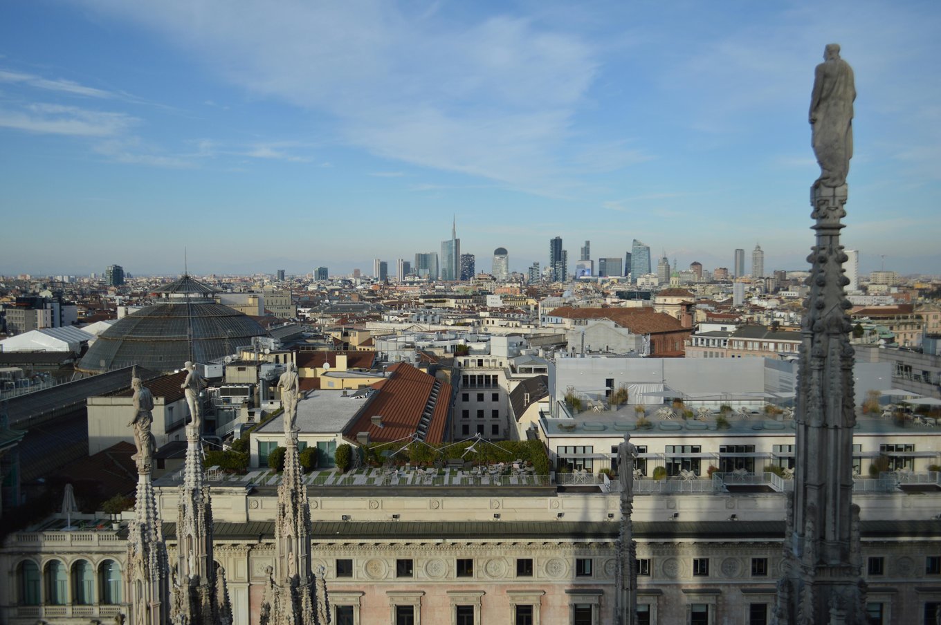 Milan skyline view from Duomo rooftop with modern skyscrapers in background