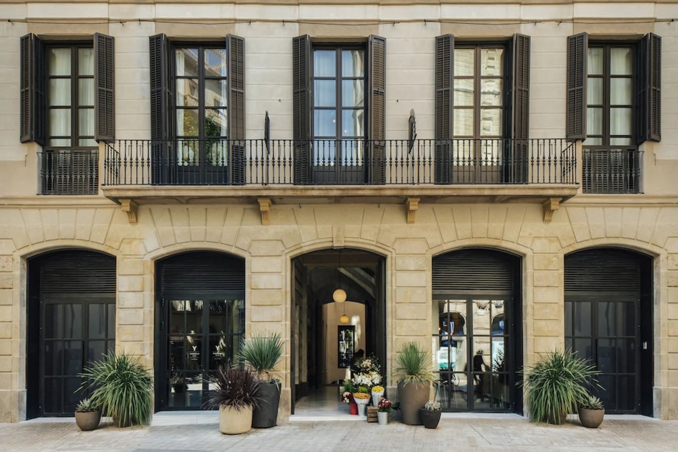 Elegant boutique hotel exterior in Barcelona with balconies and classic architecture