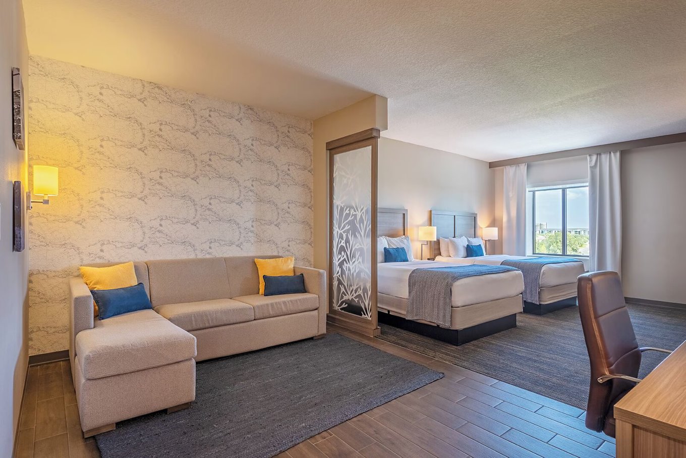 Comfortable room at Pestana Orlando Suites with two beds and a lounge area