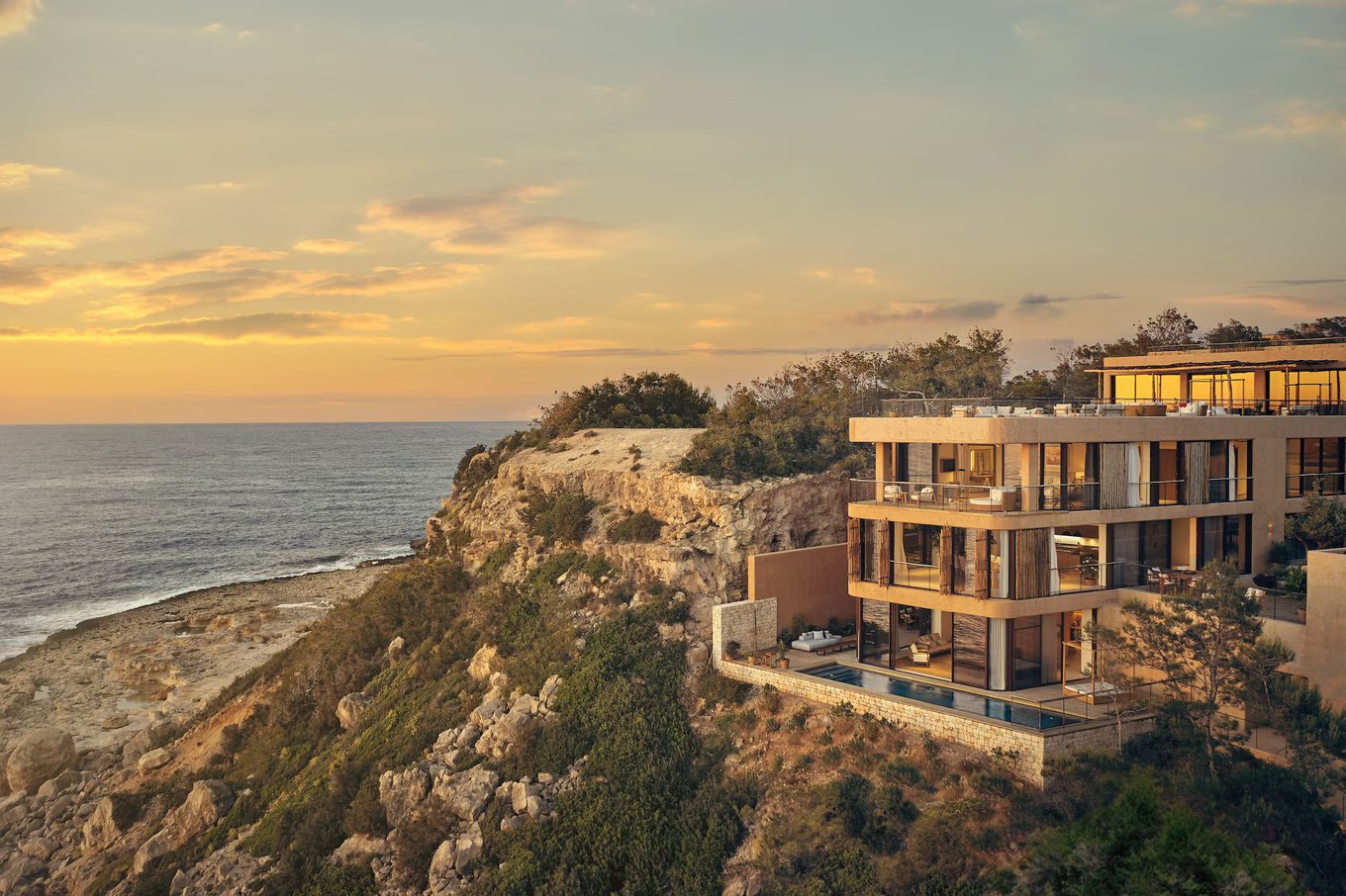 Stunning sunset view of Six Senses Ibiza perched on the rocky coastline