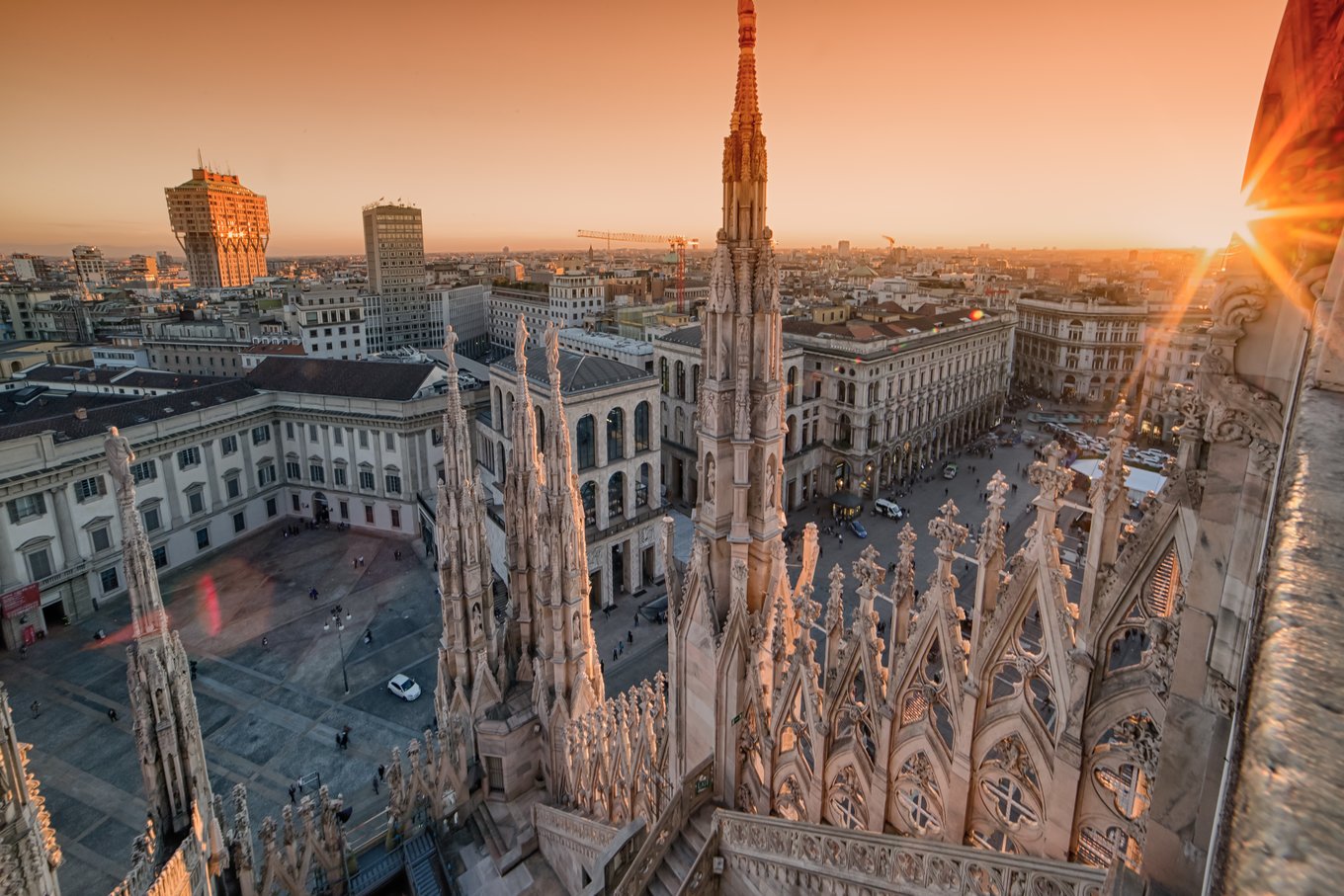 Milan cityscape with Gothic spires of the Duomo at sunset