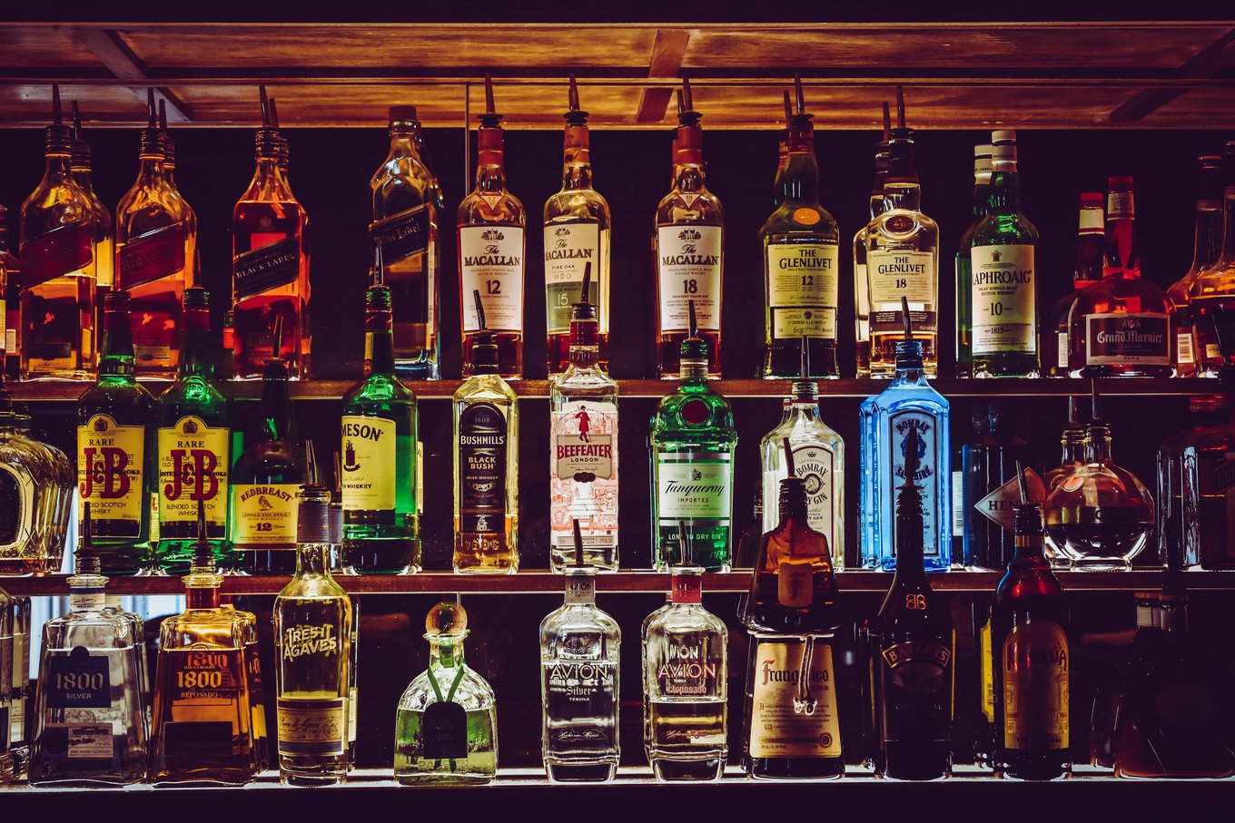 Bottles of whiskey, gin, and liqueur displayed at a Melbourne CBD bar shelf