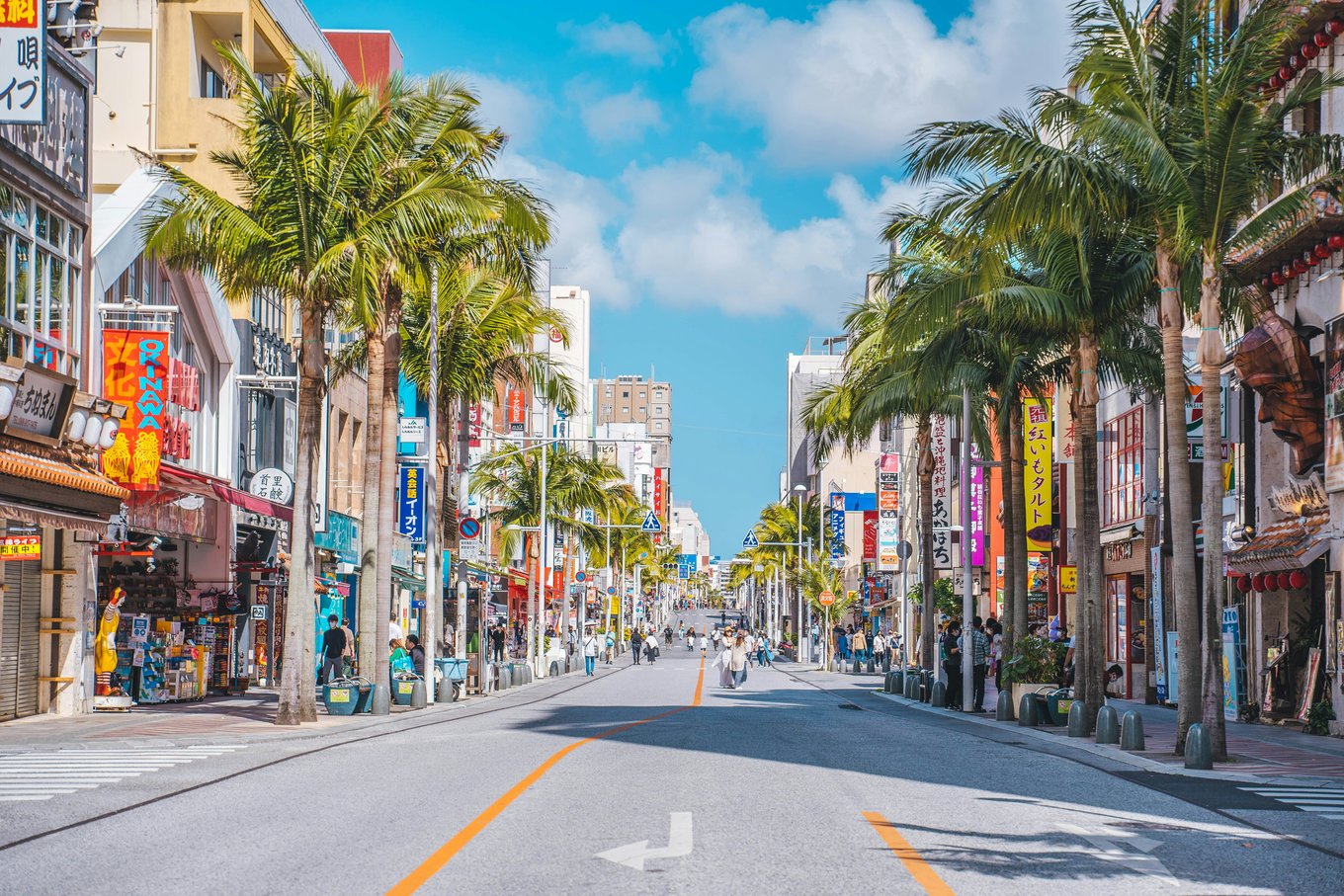 Palm-lined Kokusai Street with colorful shops in Naha, Okinawa | Photo Credit: Roméo A. on Unsplash