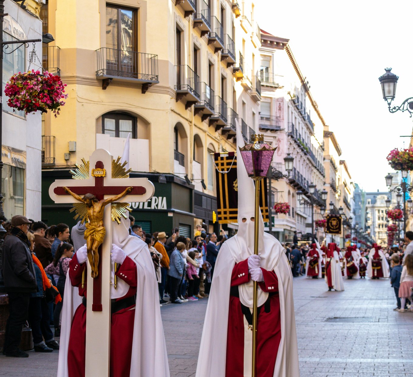Seville Semana Santa procession with participants dressed in religious attire during Holy Week makes it the perfect destination for holiday and festival lovers.