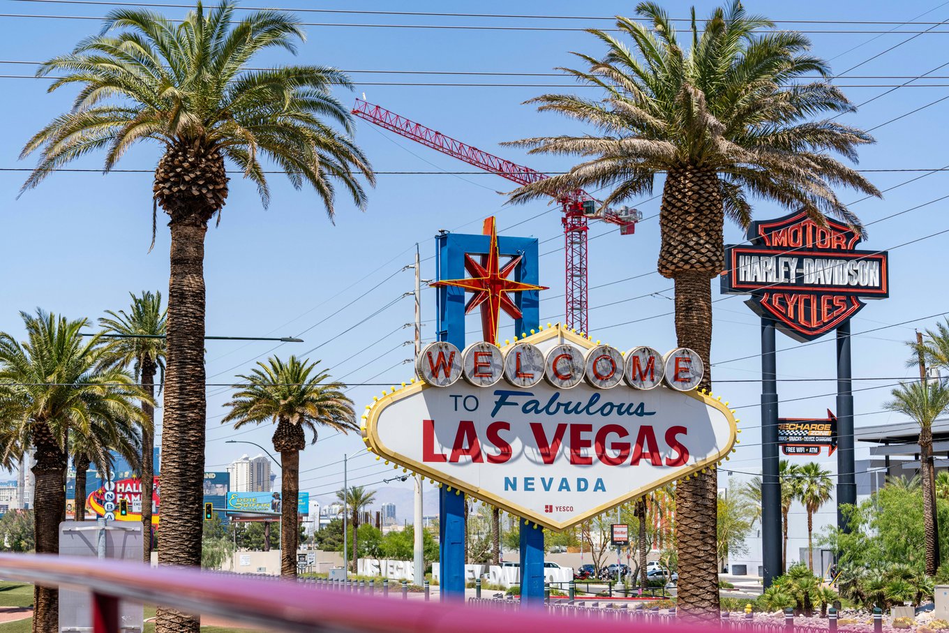 Iconic Welcome to Fabulous Las Vegas Nevada sign with palm trees under a sunny sky
