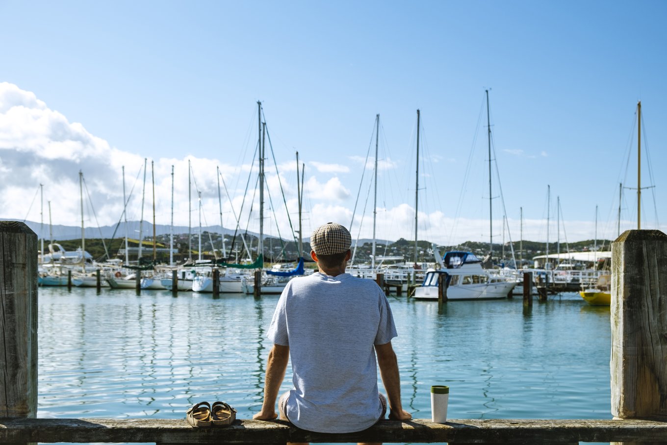 Traveler relaxing at Auckland marina with sailboats and scenic harbor views