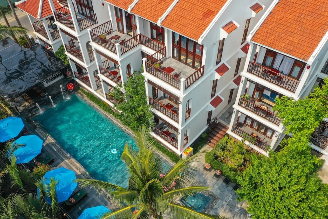 Poolside view of Hoi An Riverside Villas & Apartments with spacious balconies