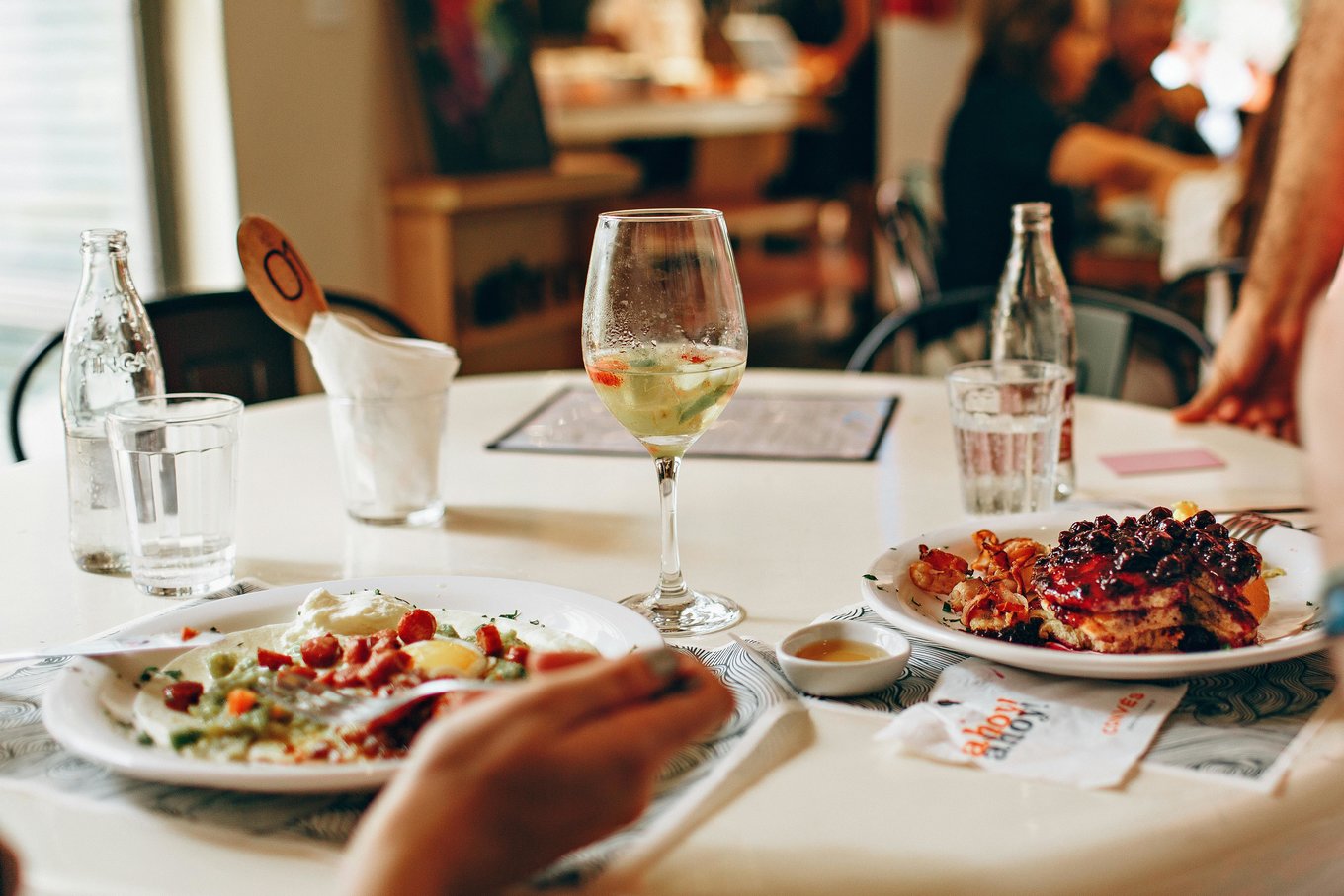 Delicious dishes served at a cozy restaurant table | Photo Credit: Helena Lopes on Pexels