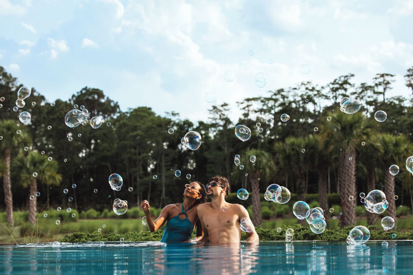 Couple relaxing at Four Seasons Orlando adults-only pool