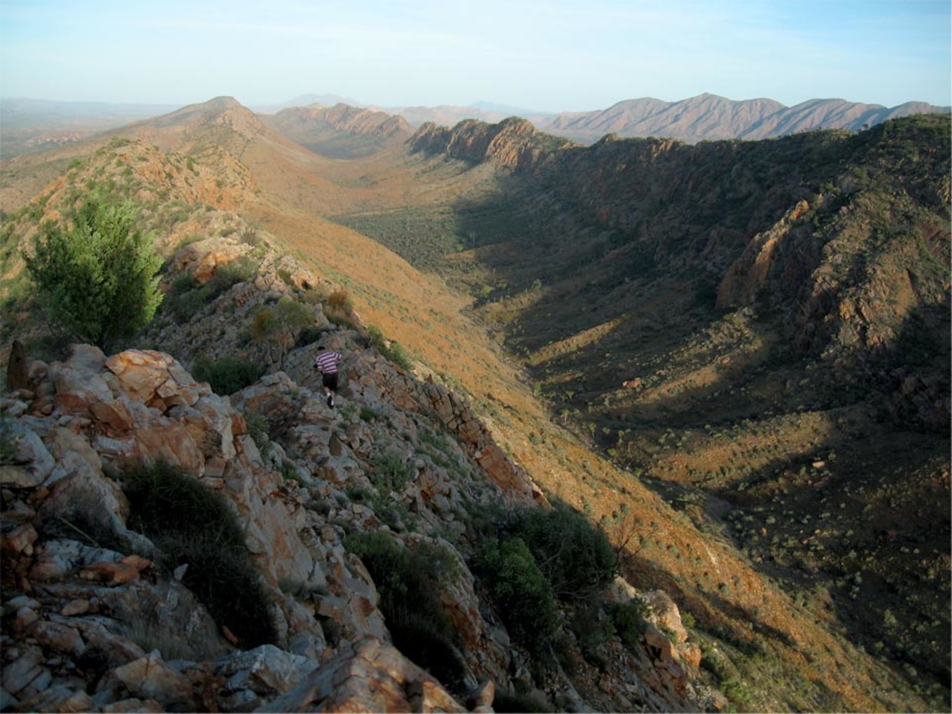Person hiking through a mountain range