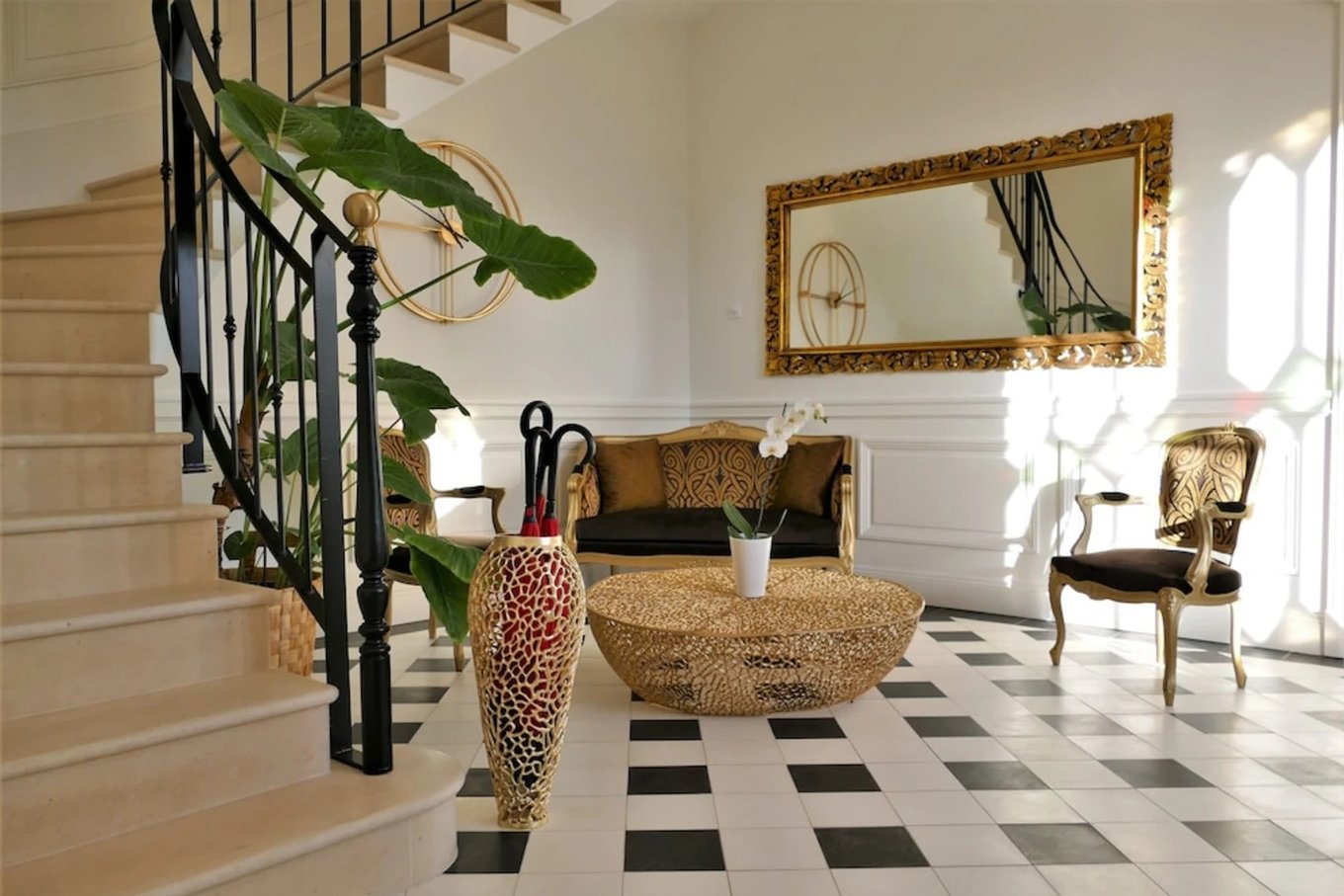 Stylish lobby staircase and lounge area at Le Clos des Queyries in Bordeaux