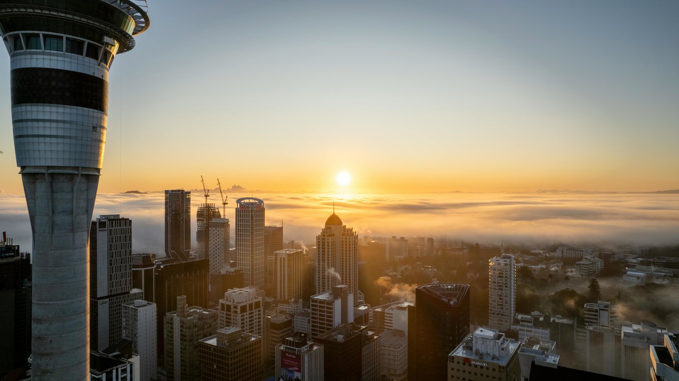 Auckland skyline at sunset with cityscape glowing over harbor | Photo from Olie Creg on Pexels