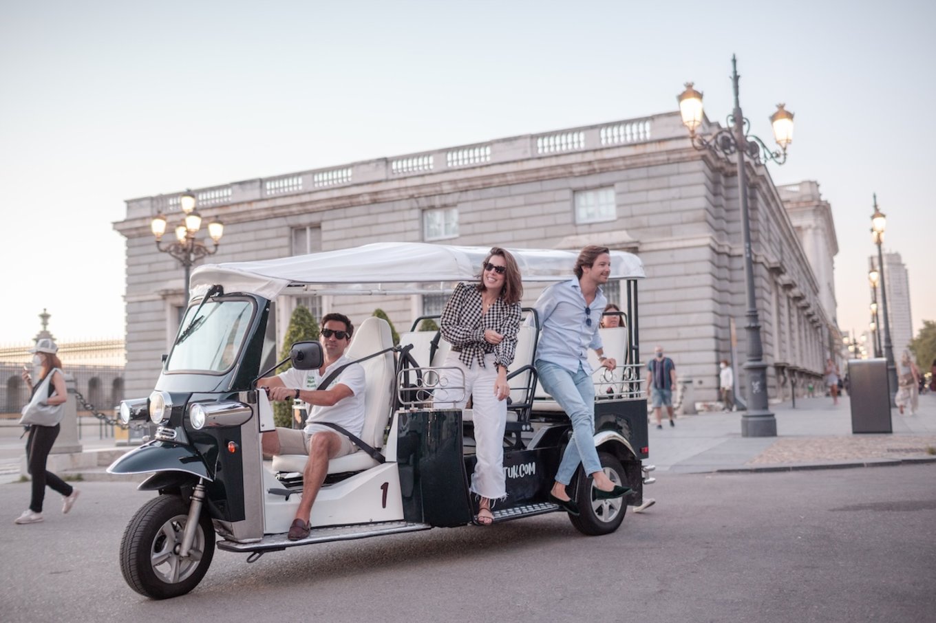 Travelers riding a tuk tuk during a sightseeing tour in Madrid