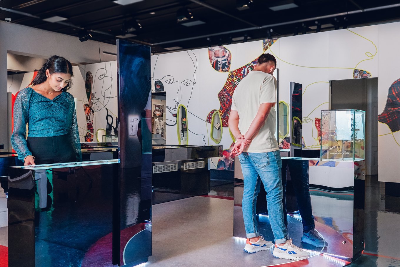 Visitors explore contemporary exhibits in Immigration Museum