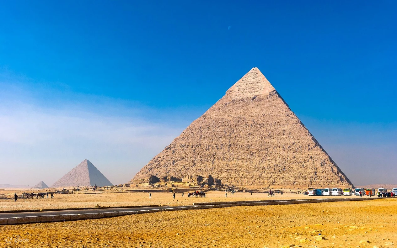 The Great Pyramids of Giza rising above the desert plateau in Cairo, Egypt