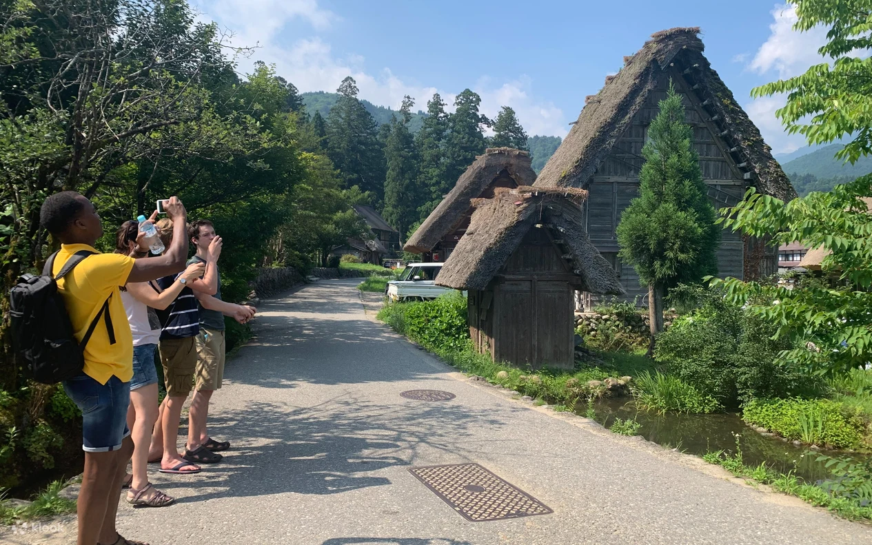 Visitors walking past traditional gassho-zukuri houses in Shirakawa-go