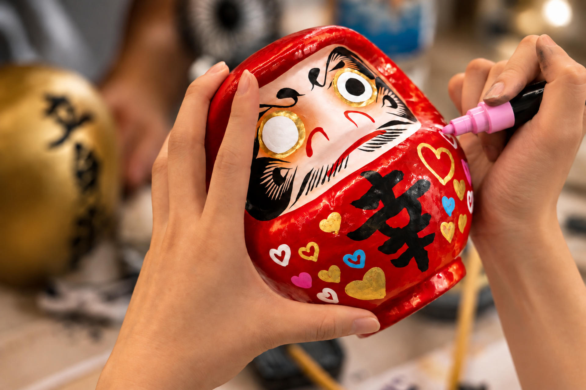 Osaka Shinsaibashi: Daruma painting experience where you write your wishes with a brush - Thumbnail 2